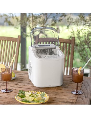 Livoo DOM484 ice maker on outdoor table with cocktails and lime garnish