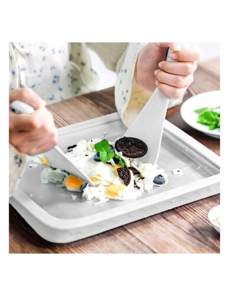 Scraping ice cream into rolls with a spatula